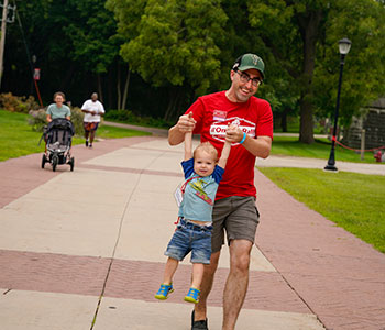 Father with child on campus. Link to Life Stage Gift Planner Under Age 60 Situations.