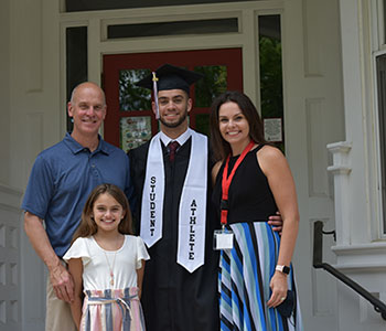 Graduate smiling with family. Link to Gifts of Appreciated Securities