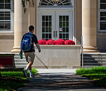 Student walking on campus. Link to Gifts by Will