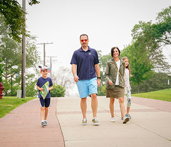 Family walking on campus. Link to Closely Held Business Stock